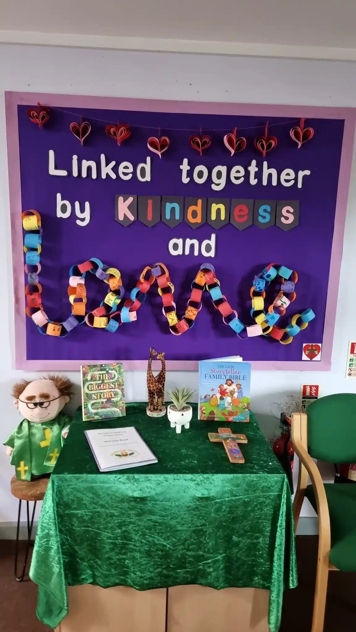 A photograph showing a wall display in Antrobus St Mark's Primary School which reads 'Linked together by kindness and love'.