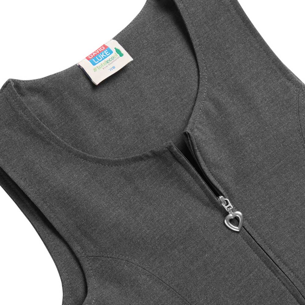 A close-up shot of the girl's grey pinafore dress by DL. Heart shaped zipper.